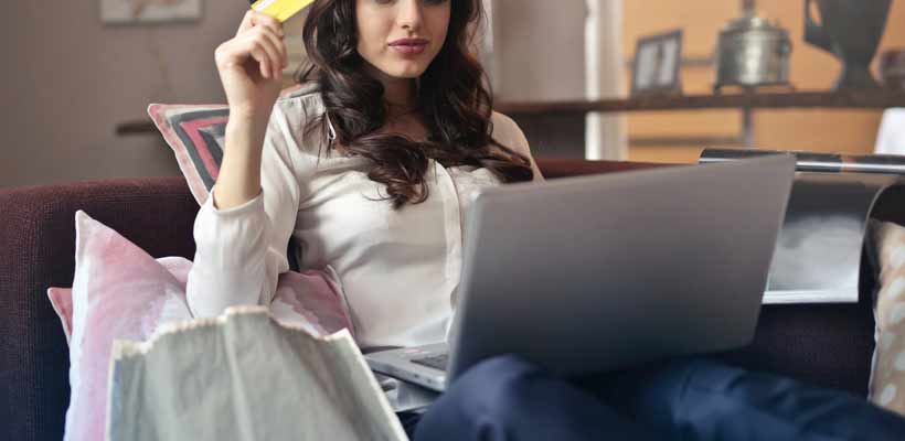 A young woman shopping on a laptop