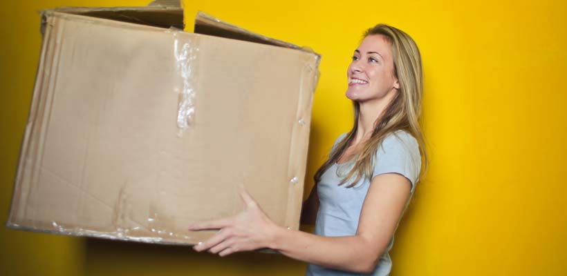 A young lady holding a large eCommerce packaging box