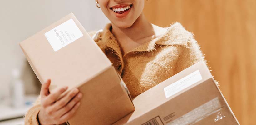 Person holding parcels containing eCommerce orders