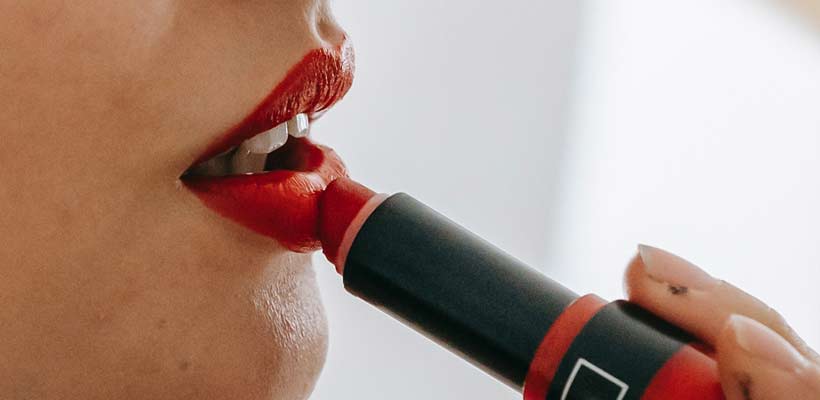 Person putting lipstick