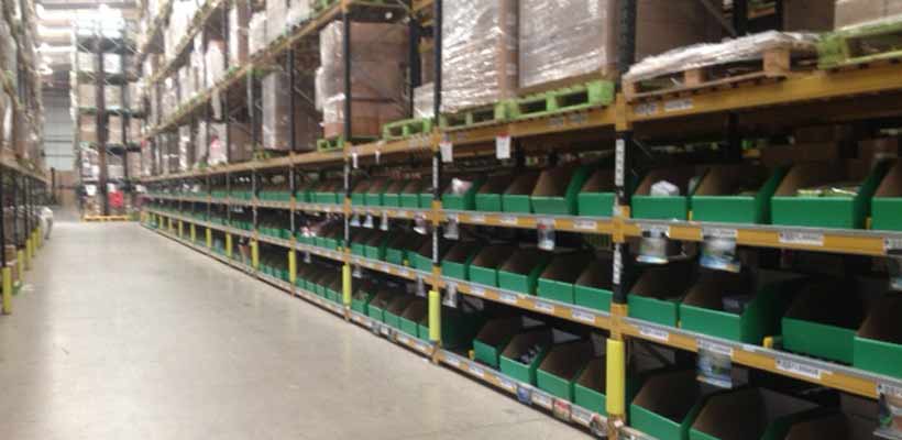 A warehouse aisle with picking bins on racking