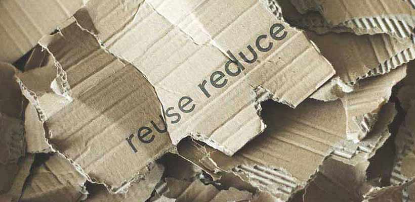 Scraps of cardboard with a sustainable packaging slogan