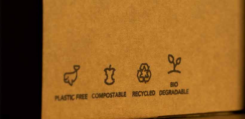 Cardboard box with environmentally friendly symbols on the side.
