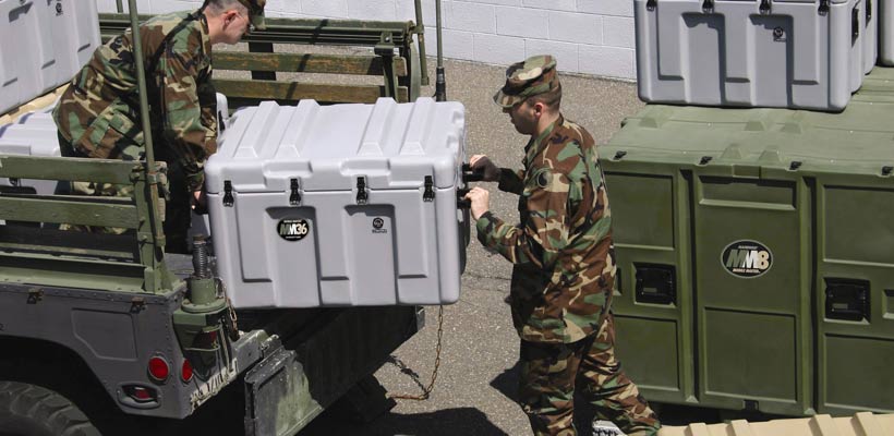 military-packaging-handles Military personnel lifting packing cases onto a vehicle.