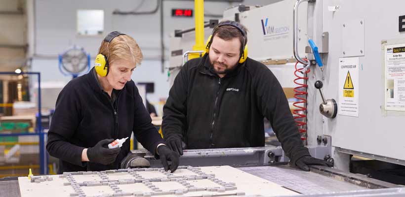 Two employees working in a factory environment