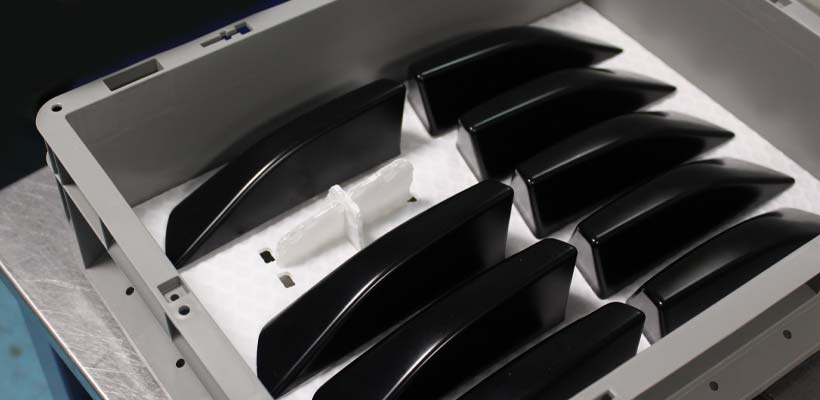 Automotive parts protection Automotive parts in a grey plastic container