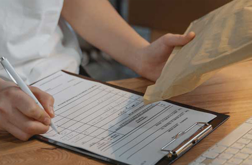 Prepare for Peak A person with a clipboard and packaging