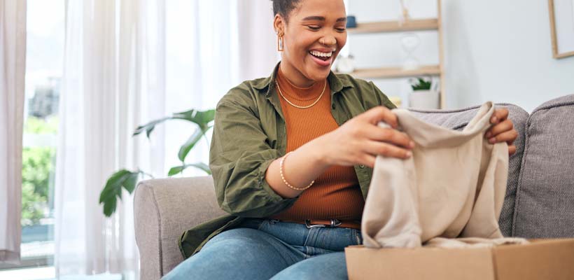 A woman opening eCommerce packaging