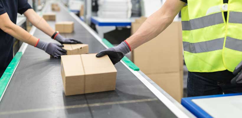 Packing times People taking boxes from a conveyor belt