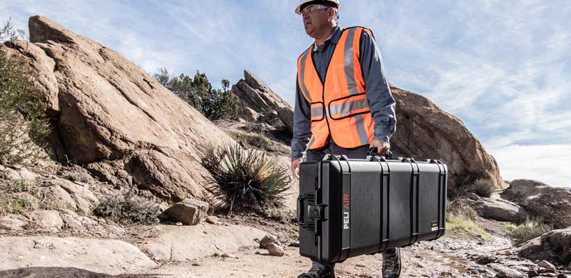 Peli Air equipment case A workman carrying a Peli Air equipment case