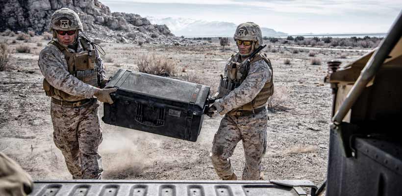 Peli Air waterproof case Two military personnel carrying a Peli Air case