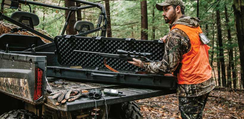 A person removing a gun from a Peli Storm rifle case
