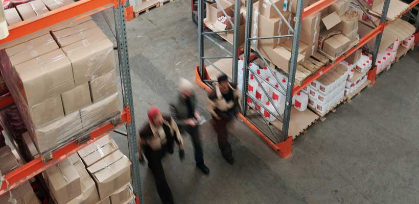 Training warehouse staff Three people undertaking training in a warehouse.