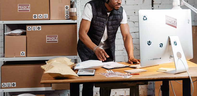 Organised packing stations A person packing eCommerce orders