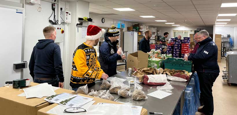 Volunteers from the Cirencester Round Table charity packing Christmas food parcels.