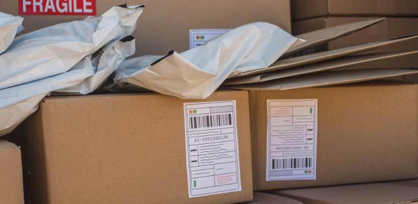 a pile of cardboard boxes and mailing bags