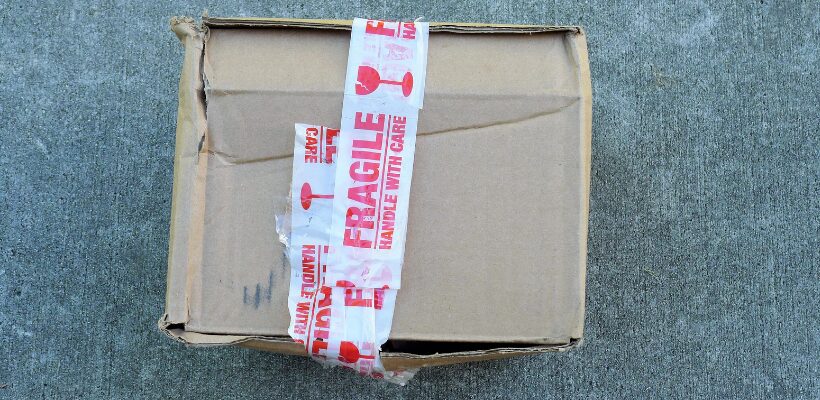 packaging mistakes img 2 a damaged cardboard box with fragile tape around it