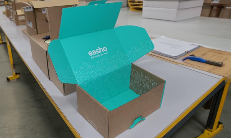 Custom eCommerce packaging on a packing bench in a fulfilment centre