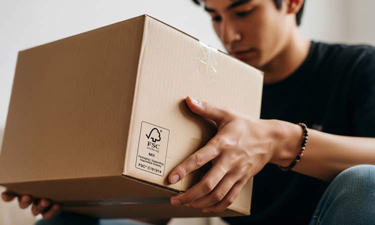 A person holding FSC packaging