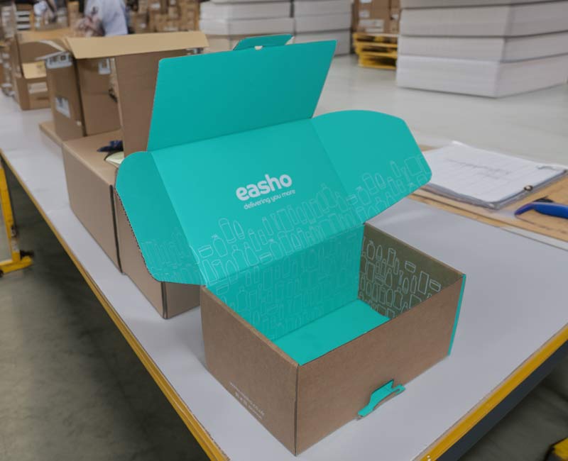 Custom eCommerce packaging on a packing bench in a fulfilment centre
