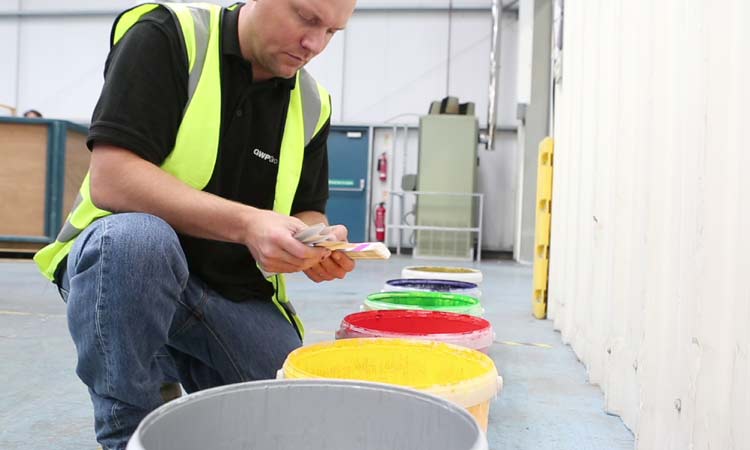 Coated corrugated board A person checking inks used to coat corrugated board