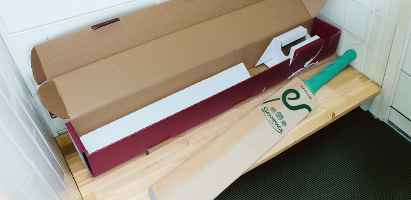 Swannack eCommerce packaging A cricket bat and its packaging in a changing room