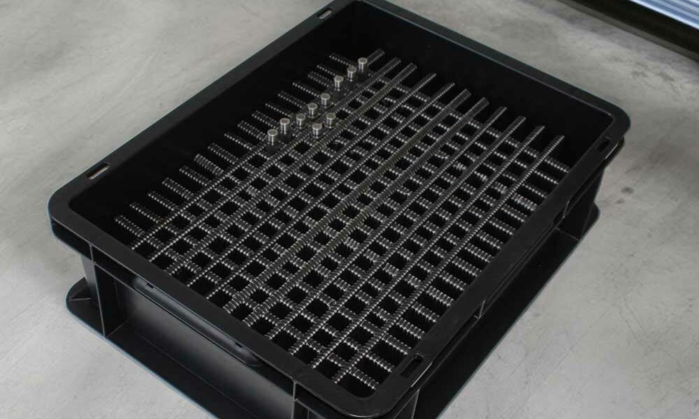 An ESD tote box on the floor in a warehouse.