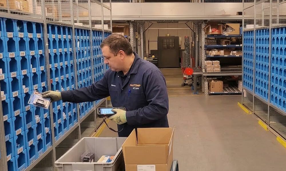 A person taking items out of pick face bins